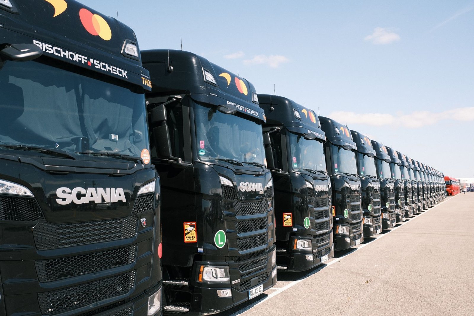Line of freight trucks staged outdoors at a distribution yard
